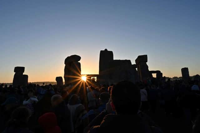 Revellers can watch the sun rise at Stonehenge, near Amesbury, in Wiltshire, southern England on June 21(photo: Saeed Khan/AFP via Getty Images)