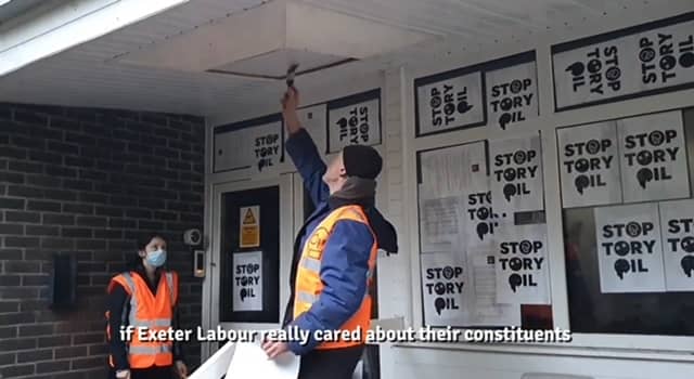 Just Stop Oil protesters fly-post Exeter Labour HQ. The protesters stuck posters and print outs of a letter they had sent to parliamentary candidate Steve Race to the building.