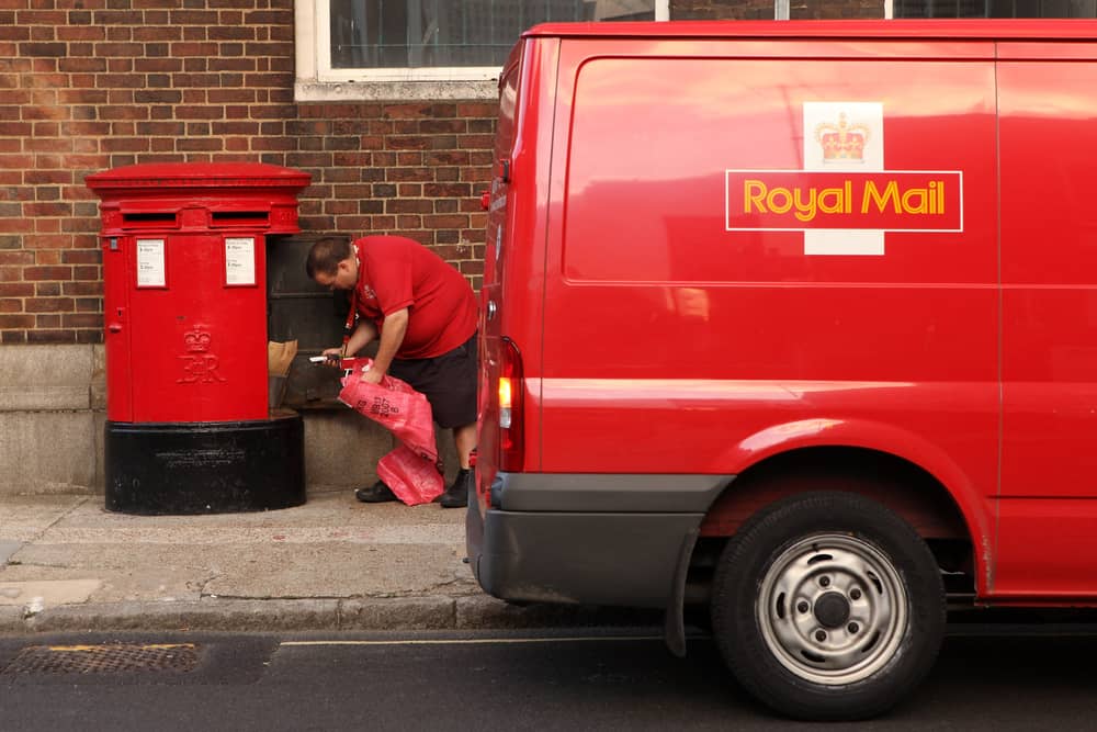 A Royal Mail employee empties a post box in London. Royal Mail has delayed its plans to scrap Saturday second-class letter deliveries until early 2026 (Photo: Oli Scarff/Getty Images)