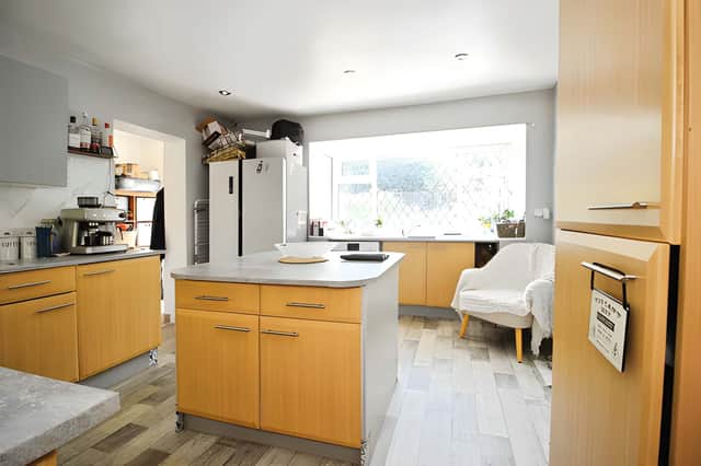A modern kitchen with island breakfast bar provides a practical setting for everyday family life