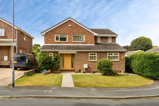 The well-presented detached home sits behind a gated driveway with a garage, creating a practical arrival at the Sandal property