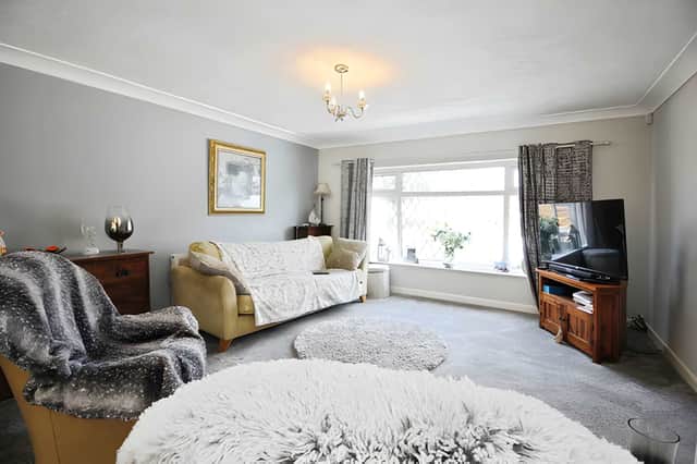 The generous lounge and dining room features modern décor, mixed flooring and a feature gas fire