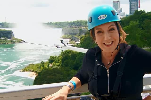 A nervous Jane whizzes down Niagara Falls on a 700m long zip line.