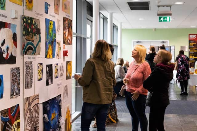 Talent on display: Visitors admire the art works