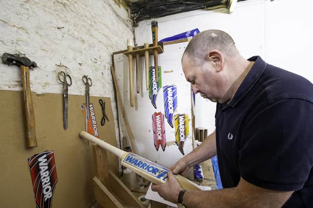 Ian stickering up one of his Warrior bats.