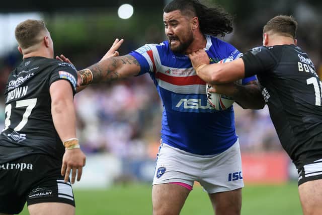 Dave Fifita is tackled by Hull's Jack Brown and Josh Bowden.