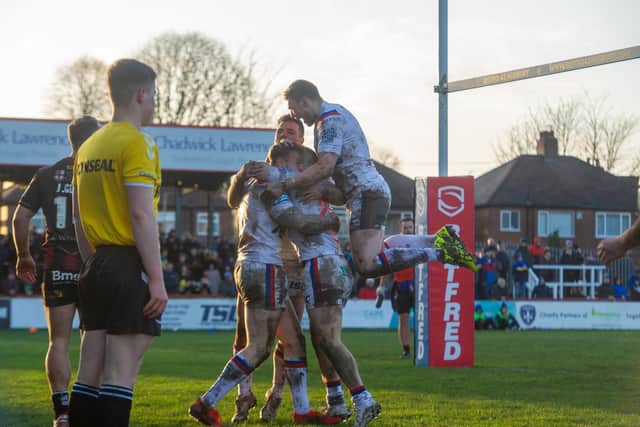 Wakefield players celebrate Tom Johnstone's clinching try against Warrington. Picture by Tony Johnson.