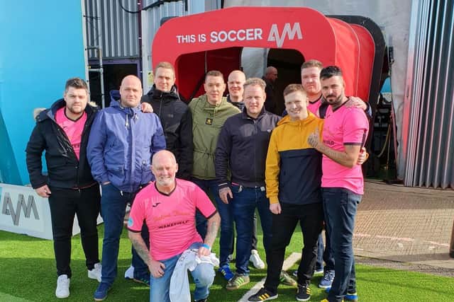 Daren Powell (right) with The Kews players an members of band Skylights on the Soccer AM show.