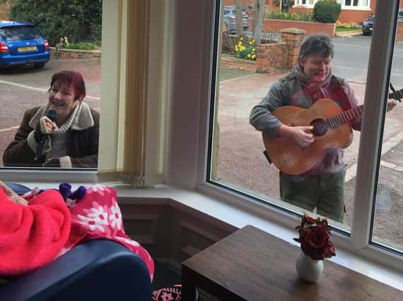 On Friday afternoon, Pam and Peter Stone, of music therapy business KeystoneKeeping Older People Smiling, performed in the car park of Glynn Residential Home