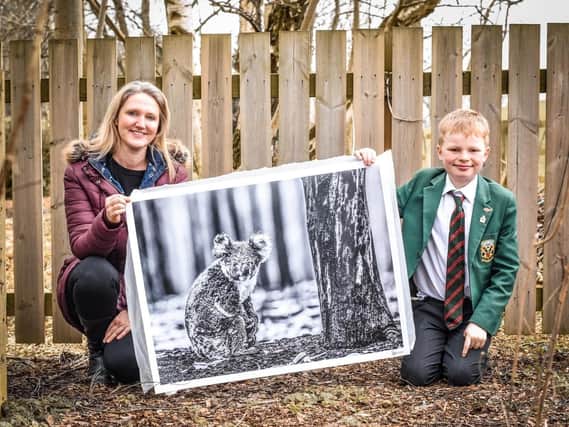 Emma Cole and Henry with the photograph from David Yarrow