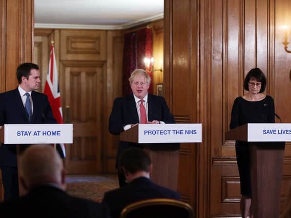 Local Government Secretary Robert Jenrick, Prime Minister Boris Johnson and Deputy Chief Medical Officer Jenny Harries give a press briefing at Downing Street on March 22, 2020