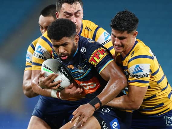 Gold Coast Titans' Kallum Watkins is tackled during the round 2 NRL match against  Parramatta Eels at Cbus Super Stadium last month (Photo by Chris Hyde/Getty Images)