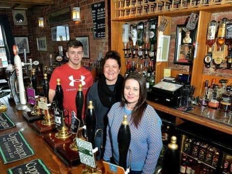 Louise Waters (middle) with staff Jack Messenger and Lou Clarke at the award-winning Harry's Bar, off Smyth Street.