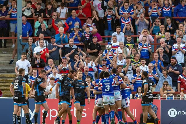 Wakefield Trinity players and fans celebrate as Huddersfield Giants are beaten at Mobile Rociket Stadium. Picture by Bruce Rollinson.