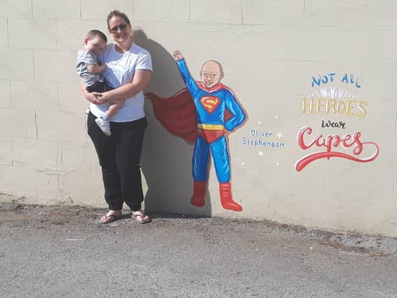 Oliver's mum, Laura, and little brother, Alfie, pictured with Rachel List's latest mural