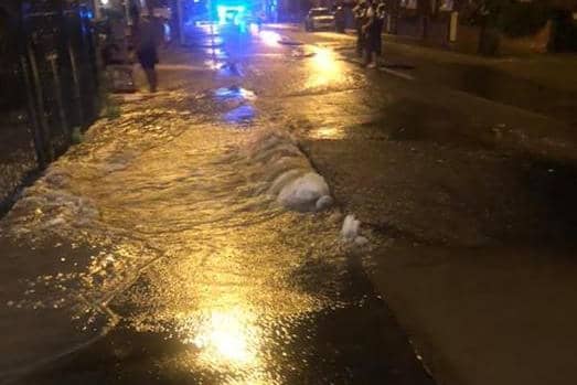 The water was seen pouring across the street (pic by Evan Guthrie)