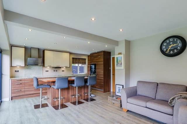 The main hub of this lovely family home is a living and dining kitchen with high specifications, bi-folding doors, and views over the garden.