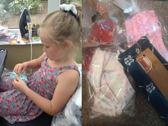 An 8-year-old girl is making face masks to raise money for the charity treating her grandfathers cancer