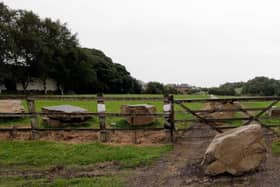 Playing fields at Grange Moor with boulders that travellers attempted to remove to gain access to the site.