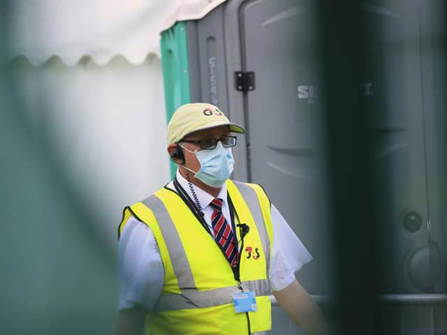 An employee at a Covid-19 testing centre in Centenary Square, Bradford, West Yorkshire, one of the areas where measures have been implemented to prevent the spread of coronavirus. Photo: PA