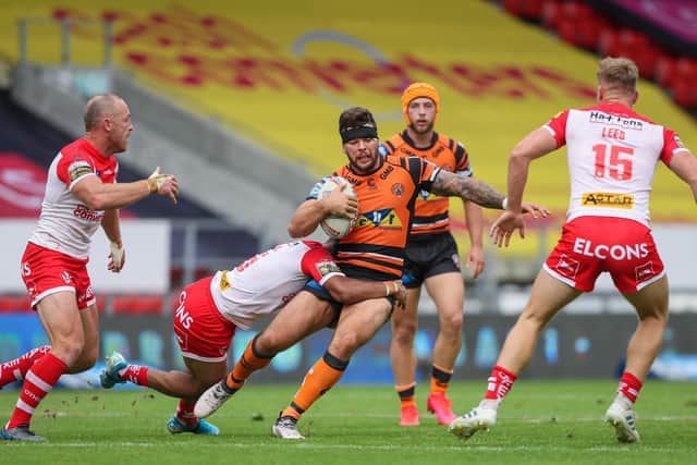 St Helens v Castleford Tigers - Totally Wicked Stadium, St Helens, England - Castleford's Alex Foster is tackled by St Helens' Regan Grace. Picture:  Alex Whitehead/SWpix.com.