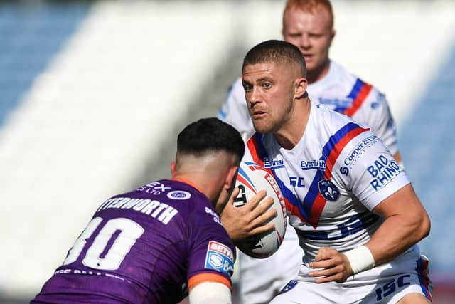 Huddersfield's Reiss Butterworth blocks the way for Ryan Hampshire, who converted Wakefield's only try of the match. Picture: Jonathan Gawthorpe/JPIMedia.