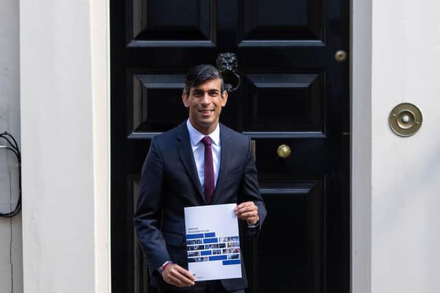 Chancellor of the Exchequer Rishi Sunak holds a copy of his Winter Economy Plan outside No 11 Downing Street before heading for the House of Commons to give MPs details of his Winter Economy Plan. Photo: PA