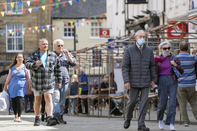 Wakefield is once again expected to be declared an 'area of concern' today, after a sharp rise in new cases of Covid-19. Above, shoppers wear masks and follow social distancing rules in Pontefract.