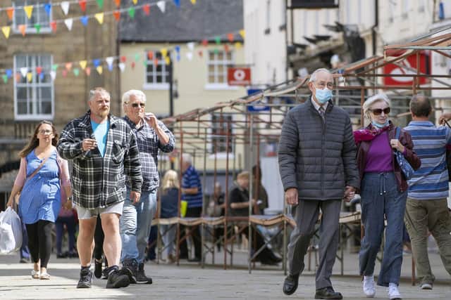 Wakefield is once again expected to be declared an 'area of concern' today, after a sharp rise in new cases of Covid-19. Above, shoppers wear masks and follow social distancing rules in Pontefract.