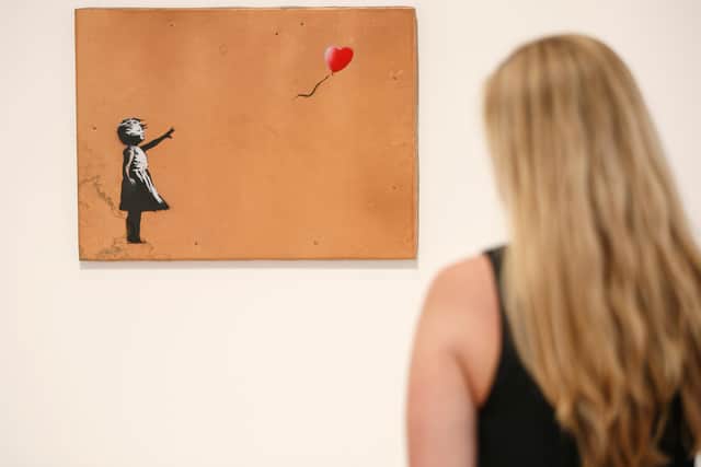 The artwork is believed to be a take on Banksy's 'Girl With Balloon', a series of 2002 murals by the artist. Photo: TOLGA AKMEN/AFP via Getty Images