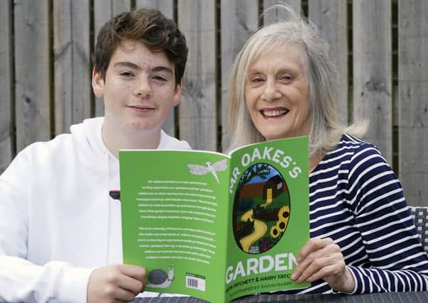 Retired lecturer Anita Fatchett and her grandson Harry have written a children's book called Mr Oake's Garden. Picture Scott Merrylees