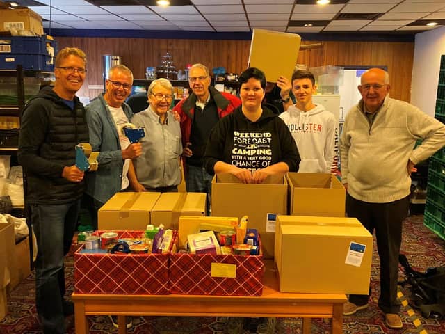 Gemma Jimmison from the Wakefield Express and members of the Rotary Club of
Wakefield Chantry packing hampers in 2019.