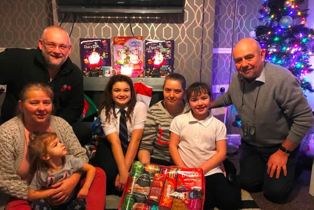 One of the families who received hampers in 2019 with Kevin Dobson from CAP (l) and Bob Guard from the Rotary Club of Wakefield Chantry (r).