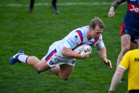 Eddie Battye dives in for a try for Wakefield Trinity in the 48-18 win over Hull KR yesterday. Picture: James Hardisty/JPIMedia.