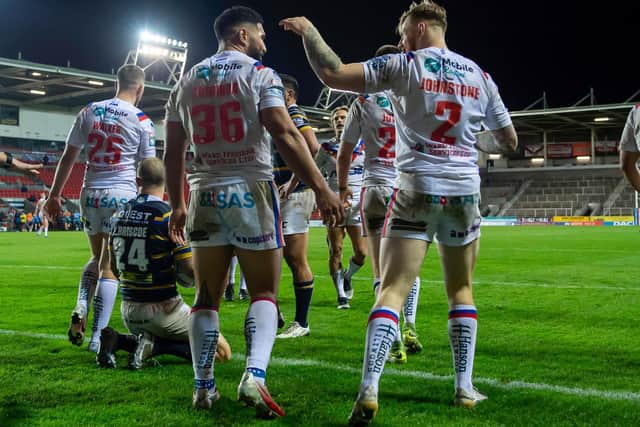 Picture by Allan McKenzie/SWpix.com - 29/10/2020 - Rugby League - Betfred Super League - Leeds Rhinos v Wakefield Trinity - The Totally Wicked Stadium, Langtree Park, St Helens, England - Wakefield's Kelepi Tanginoa & Tom Johnstone celebrate victory over Leeds.