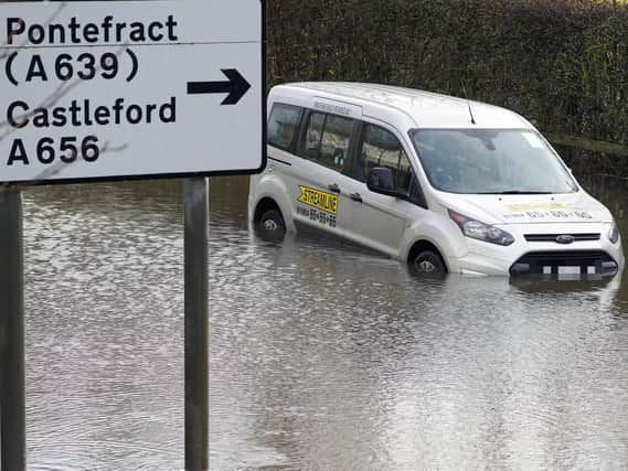 An urgent review of flood defences and drainage in the Five Towns is needed, an MP has said, after properties were flooded during a weekend of heavy rain. Pictured is a car braving a flooded Barnsdale Road in Castleford.