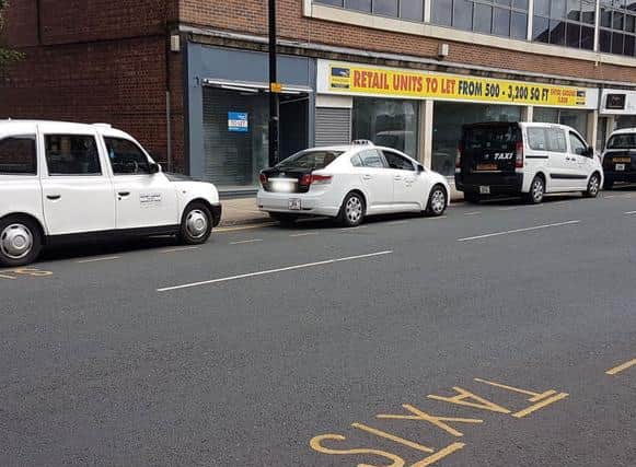 Hackney carriage vehicles lined up in Wakefield city centre.