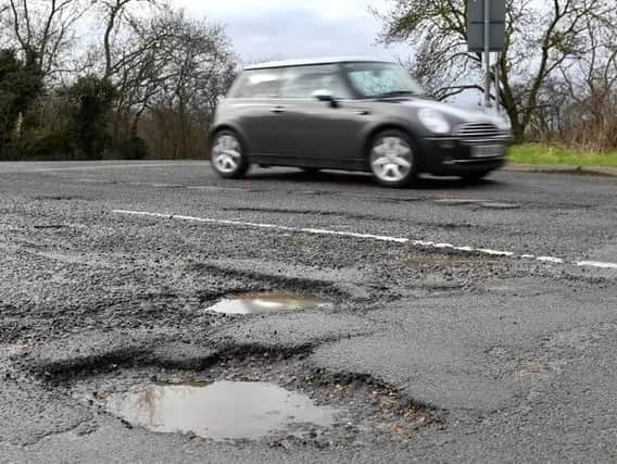 Government funding to repair damaged roads in West Yorkshire has been slashed by more than a quarter for the coming year.