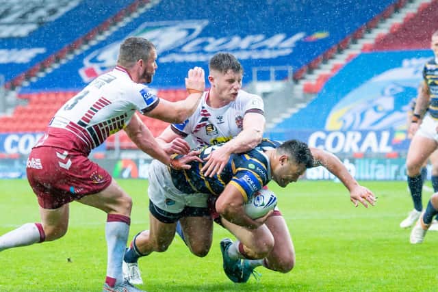 Leeds Rhinos and Wigan Warriors in action last season. Their Round Three game will be televised live by Sky Sports. (ALLAN MCKENZIE/SWPIX)
