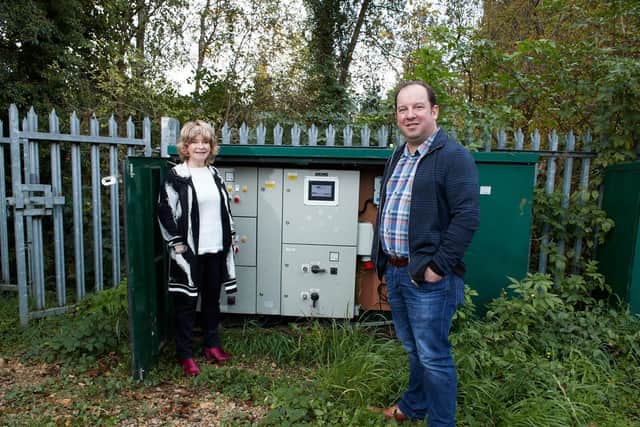 Council leader Denise Jeffery and Cabinet member Matthew Morley alongside the pumping station after it was repaired last year.