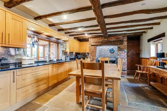 Its rustic style adds warmth to the spacious fitted kitchen within the property