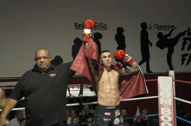 Aaron Slimane has his hands raised after his fight with Scott Richardson.