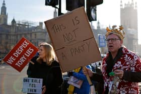 PROTEST: Demonstrators hold placards as they protest near the House of Commons. Photo: Getty Images
