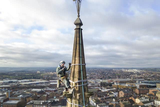 Dan Bottomley carries out repairs to the cathedral spire.  Photo Scott Merrylees