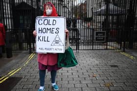 A protestor holds a placard highlighting the excess winter deaths caused by fuel poverty. Photo: Getty Images