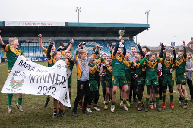 Kippax Welfare U12s celebrate winning the BARLA Supplementary Cup at Featherstone Rovers’ Millennium Stadium. Inset: man of the match Noah White about to place the ball down for a try. Picture: Simon Hall