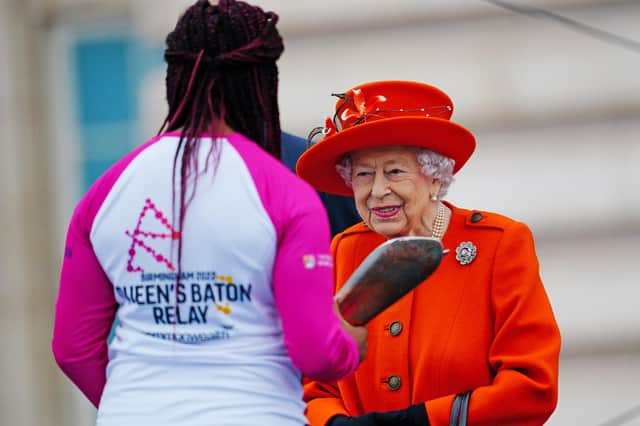 The Queen passes her baton to British parasport athlete Kadeena Cox OBE, during the launch of the Queen’s Baton Relay for Birmingham 2022, at Buckingham Palace  Photo Getty Images.
