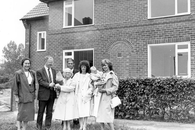 Coun George Mudie presents keys to new tenants of Brander Mount in Gipton. This was the conversion of 12 'cottage' style flats to 6 2-bedroomed semi-detached homes carried out as part of long-term plan by Leeds City Council to improve the standard of older housing estates in the city.