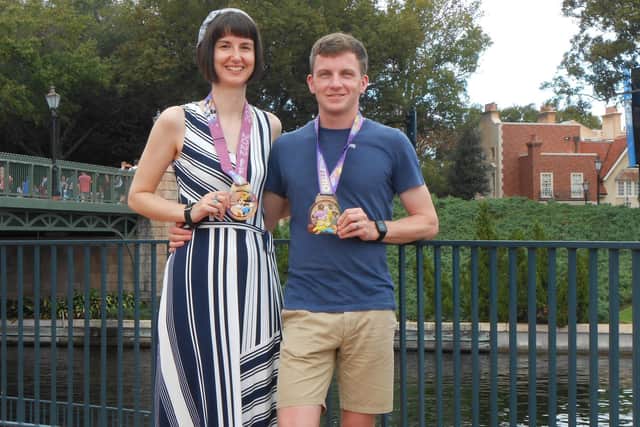 Honeymooning Rodillian Runners Claire and Eddy Lowe show off their medals after taking part in races at DisneyWorld, Florida.