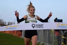 All smiles as Wakefield Harriers runner Abbey Brooke crosses the finishing line to win the North of England U20 Cross Country title.